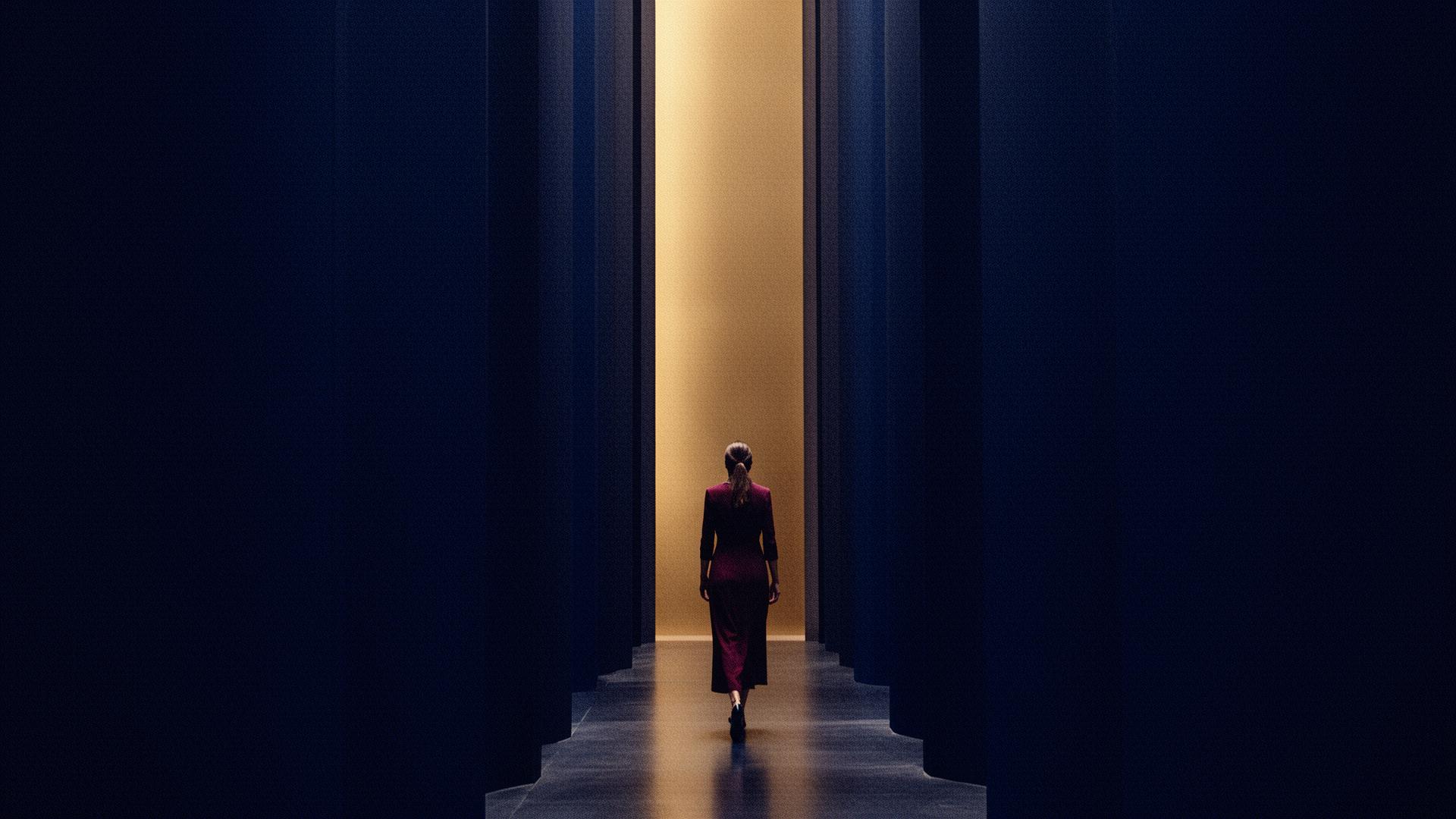 A woman walking toward a warm light